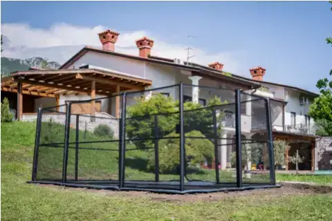 A large house surrounded by a fence, showcasing its spacious exterior and well-defined boundaries.